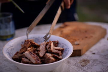 Slicing pork barbecue recipe on a hand made vintage chopping board