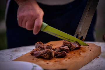 Slicing pork barbecue recipe on a hand made vintage chopping board
