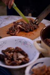 Slicing pork barbecue recipe on a hand made vintage chopping board