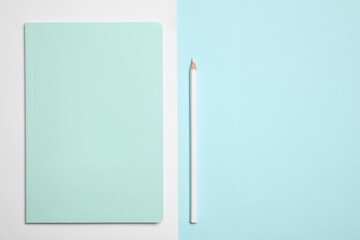 Stylish notebook and pencil on color background, flat lay. Space for text
