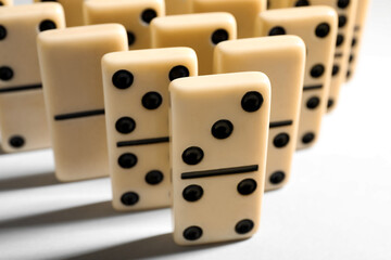 Many domino tiles on white background, closeup