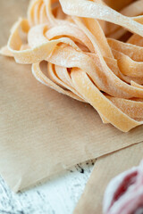 Italian classic pasta on a light wooden background