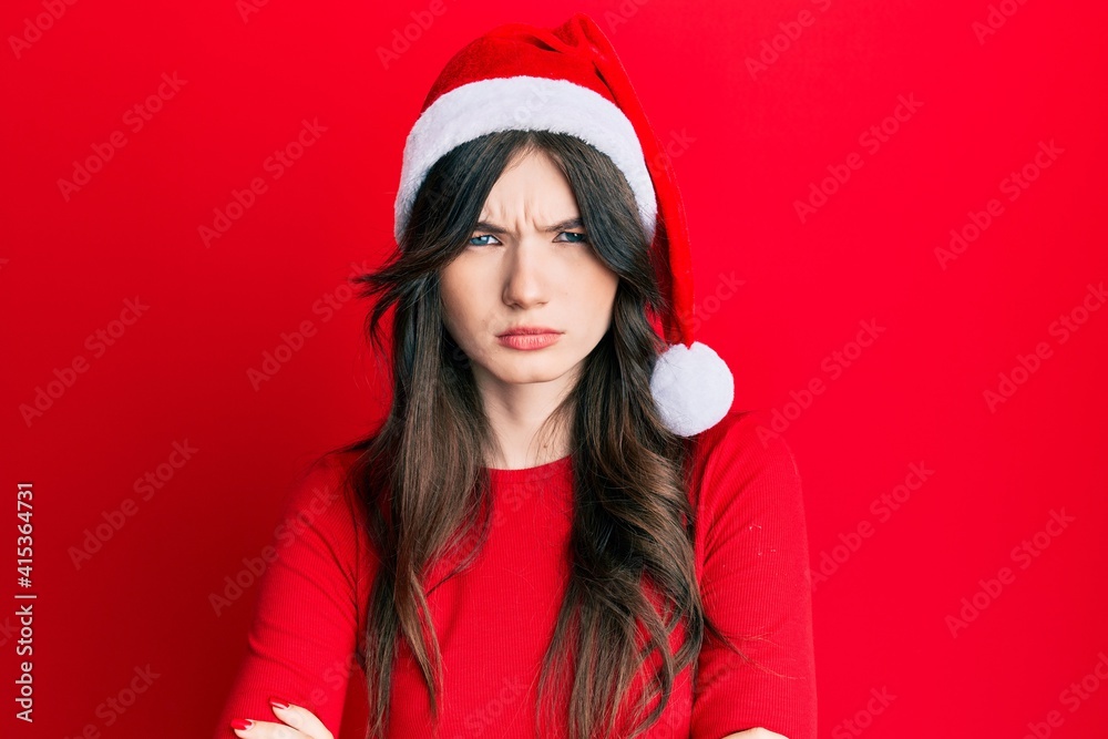 Sticker young beautiful caucasian girl wearing christmas hat skeptic and nervous, disapproving expression on