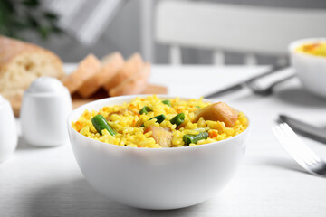 Delicious rice pilaf with meat served on white table