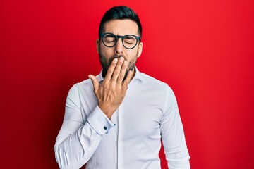 Young hispanic businessman wearing shirt and glasses bored yawning tired covering mouth with hand. restless and sleepiness.