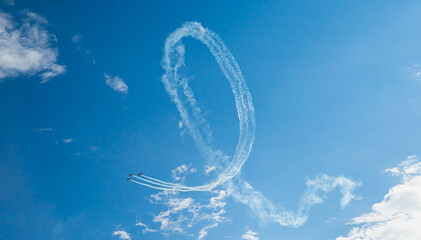 Stunt aircrafts performing incredible aerobatics. Aerial manoeuvre stunts. Planes does loop stunt with smoke trails
