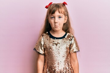 Little caucasian girl kid wearing festive sequins dress depressed and worry for distress, crying angry and afraid. sad expression.