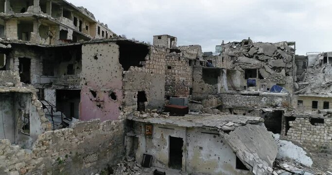 Drone flying over ruins of buildings in Aleppo, Syria. We can see destroyed buildings in the street of the city 4K