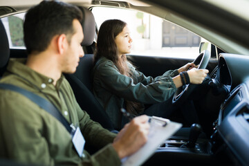 Young man writing the score of a teen driver