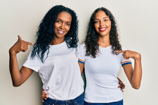 African American Mother And Daughter Wearing Casual White Tshirt Pointing Finger To One Self Smiling Happy And Proud