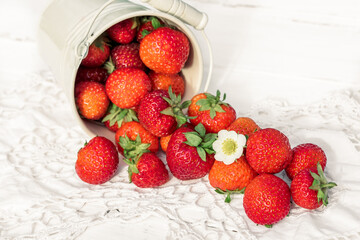 strawberries on a white wooden old background, knitted napkin, copy space.