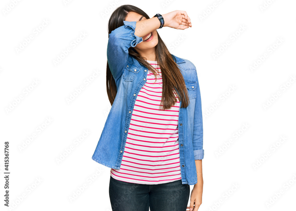 Poster young brunette woman wearing casual clothes covering eyes with arm smiling cheerful and funny. blind