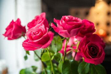 Beautiful flower bouquet of pink rose. Big bouquet of roses in vase on table near the window.