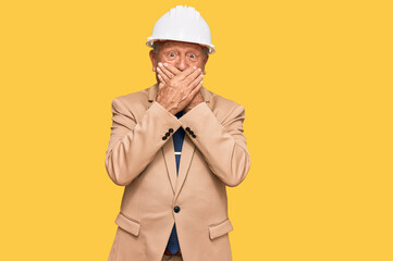 Senior caucasian man wearing architect hardhat shocked covering mouth with hands for mistake. secret concept.
