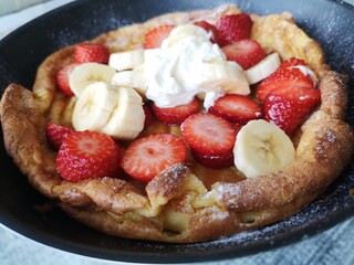 Homemade sweet breakfast. Bread with banana and strawberries. Best Dessert to enjoy. Tasty morning breakfast. Close up of food in the kitchen. Pancakes