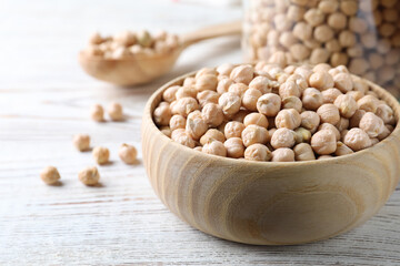 Raw chickpeas on white wooden table, closeup