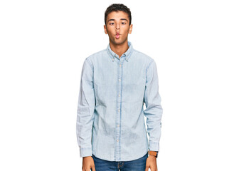 Fototapeta premium Young handsome african american man wearing casual clothes making fish face with lips, crazy and comical gesture. funny expression.