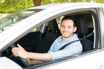 Portrait of a hispanic driver working on car sharing service