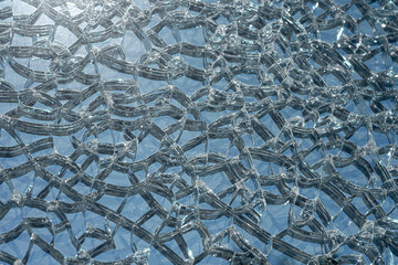 Broken toughened glass. The texture of the cracked glass