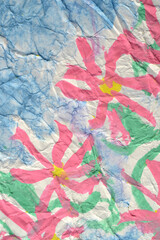 pink flower on blue crumpled paper