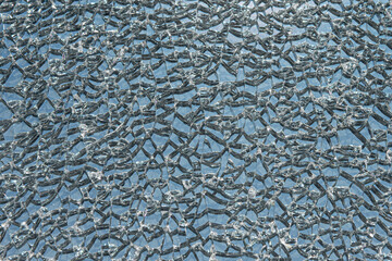 Broken toughened glass. The texture of the cracked glass