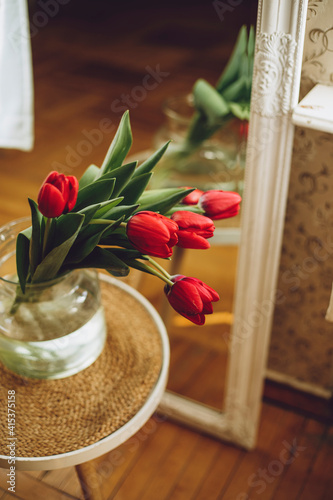macro photo of a bouquet with tulips in a transparent vase and blurred background bokeh effect March 8 mother's day