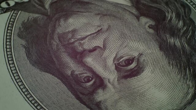 Benjamin Franklin face on one hundred dollars banknote of american money slow rotating. Extreme close-up portrait of president Franklin. Moving on circle. Slow motion. Background.