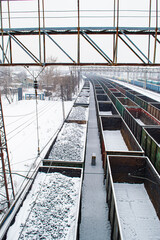 Cars with coal in the snow.