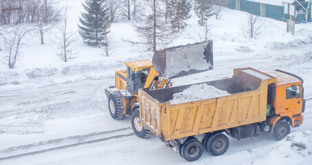 Cleaning and cleaning of roads in the city from snow in winter