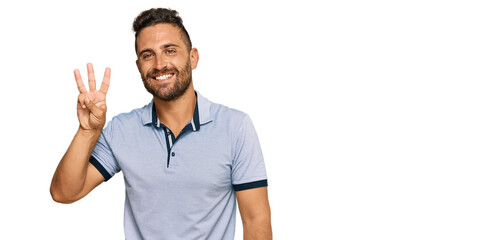 Handsome man with beard wearing casual clothes showing and pointing up with fingers number three while smiling confident and happy.