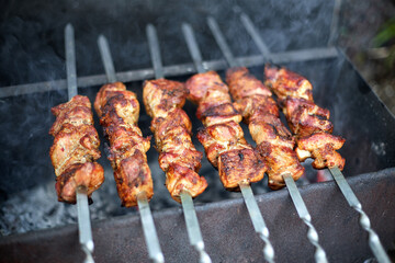 Kebabs in nature, on an old homemade grill, with a shallow depth of field