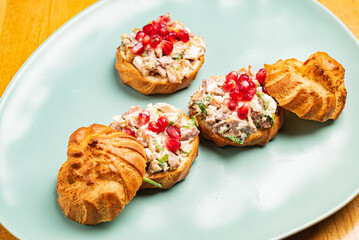 canape with meat salad and pomegranate seeds