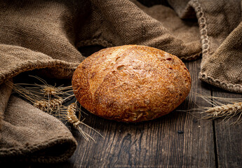 Freshly baked traditional bread on wooden table.