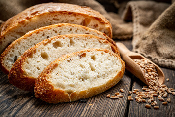 Freshly baked traditional bread on wooden table.