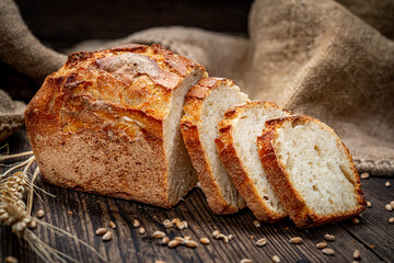Freshly baked traditional bread on wooden table.