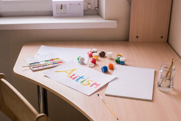 Creative design for april 2, autism world awareness day.  Painting word autism with paints