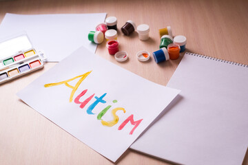 Creative design for april 2, autism world awareness day.  Painting word autism with paints