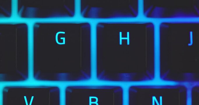 Closeup of illuminated mechanical keyboard keys in motion