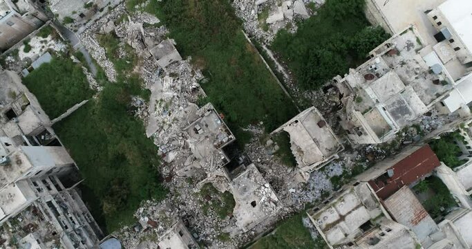 Aerial view with a drone above Aleppo in Syria 10 years after the civil war. We can see buildings in ruins after bombing 4K