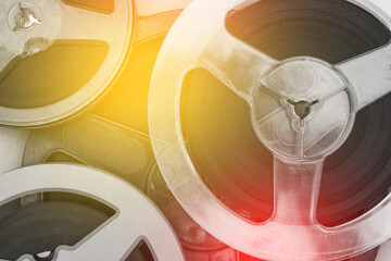 Old reels of films and music. Cinematography and entertainment. Bobbin close-up with toning. Retro style