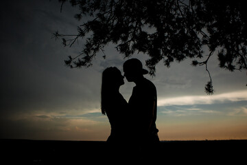 Silhouette of a couple in love at sunset
