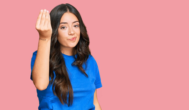 Beautiful brunette young woman wearing casual clothes doing italian gesture with hand and fingers confident expression