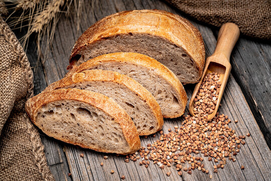 Freshly baked traditional bread on wooden table.