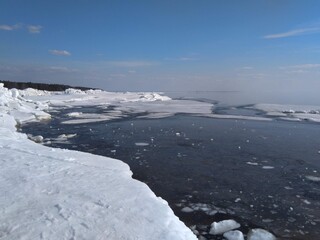 Aerial abstract melting ice on sea. The sunlit horizon line