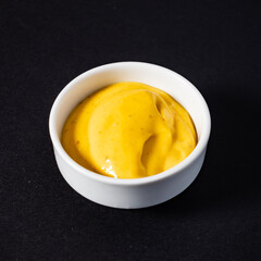 mustard sauce on the black background