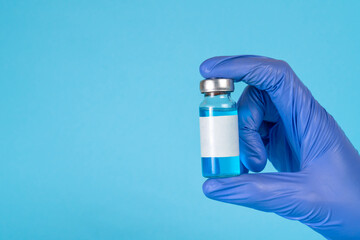 Naklejka premium Doctor, nurse, scientist hand in blue gloves holding flu, measles, coronavirus, covid-19 vaccine disease preparing for child, baby, adult, man and woman vaccination shot, medicine and drug concept.