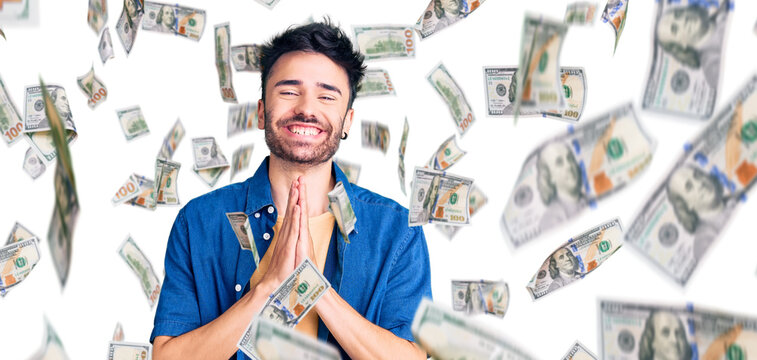 Young hispanic man wearing casual clothes praying with hands together asking for forgiveness smiling confident.