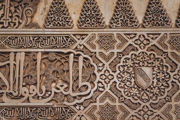 details of the arabesque decorations, typical of the moorish architecture than can be found in the Nasrid palaces of the Alhambra complex in Granada (Spain)