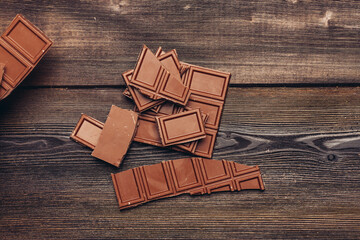 milk chocolate cubes on a wooden table dessert bar