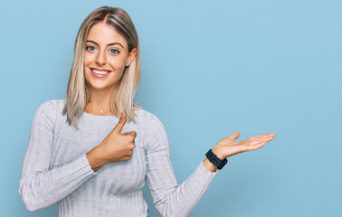Beautiful blonde woman wearing casual clothes showing palm hand and doing ok gesture with thumbs...